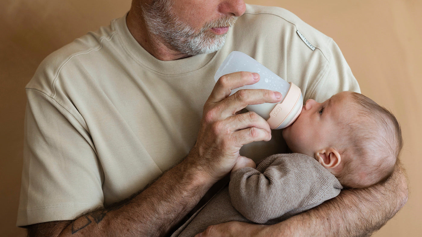 Moment de tendresse entre un papa et son nourrisson pendant le biberon.