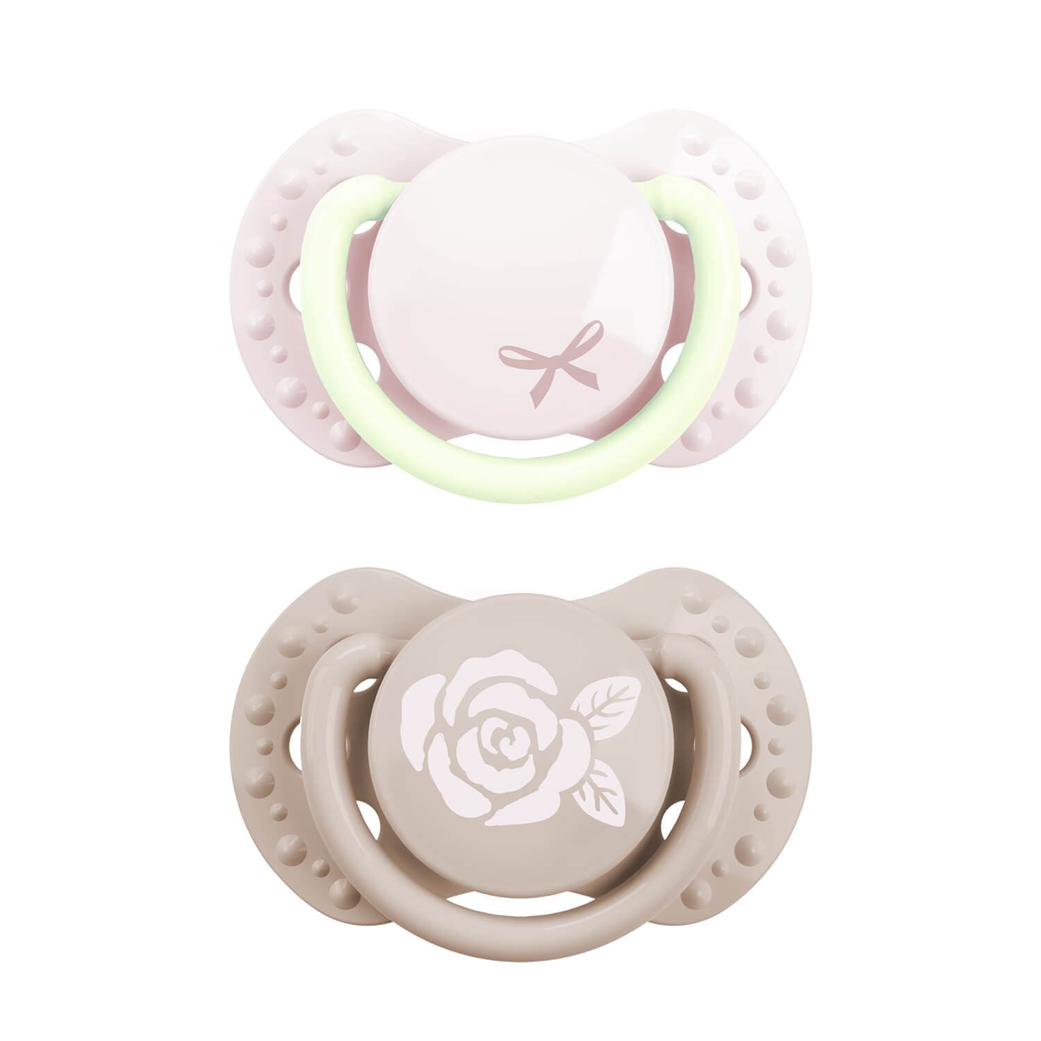 Deux sucettes pour bébé, l'une rose avec anneau phosphorescent et motif nœud, l'autre beige avec motif rose, idéales pour fille