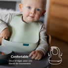 Enfant dans une chaise haute avec le bavoir en silicone – Difrax LOVI Baby Eet- & Drinkset Pistachio, bavoir confortable, doux et léger pour une liberté de mouvement.